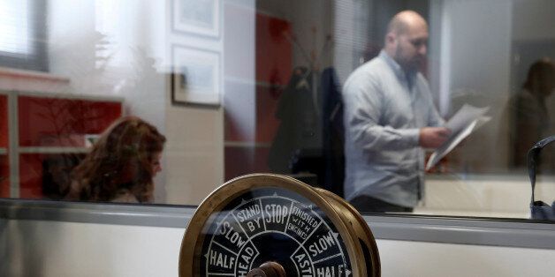 Employees of Vanos marine supply company work inside an office at Kaminia suburb in Piraeus, near Athens April 2, 2014. REUTERS/Yorgos Karahalis/File Photo GLOBAL BUSINESS WEEK AHEAD PACKAGE Ã SEARCH ÃBUSINESS WEEK AHEAD 3 OCTÃ FOR ALL IMAGES