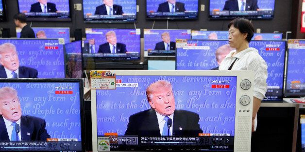 A customer watches TV setbroadcast of the first presidential debate between U.S. Democratic presidential candidate Hillary Clinton and Republican presidential nominee Donald Trump, in Seoul, South Korea, September 27, 2016. REUTERS/Kim Hong-Ji