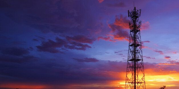 Silhouettes telecommunication tower at sunset. Beautiful sky.