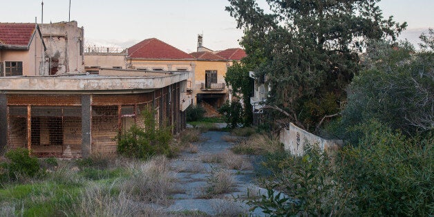 FAMAGUSTA, CYPRUS - JANUARY 05: Nature covers the abandoned houses of the Varosha quarter on January 5, 2017 in Famagusta, Cyprus. Prior to the Turkish invasion of Cyprus in 1974, the abandoned quarter of Varosha was the modern tourist area of the city, and one of the most important tourist destinations in the world. (Photo by Awakening/Getty Images)