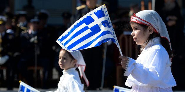 Young girls holding Greek National flags march during the parade, on the streets of Mytilene, on the island of Lesbos, to commemorate the country's entry into the Second World War, after Italian forces invaded Greece from Albania on 28 October 1940. Mytilene, Lesbos Island, Greece, on 28 October 2015. A high school pupil holding the Greek flag leads his school during the Pupils march during the parade to commemorate Greece entry into the Second World War. (Photo by Artur Widak/NurPhoto) (Photo by NurPhoto/NurPhoto via Getty Images)