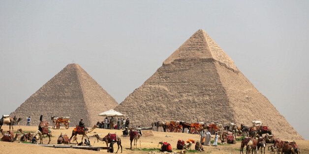 A group of camels and horses stand idle in front of the Great Pyramids awaiting tourists in Giza, Egypt, March 29, 2017. REUTERS/Mohamed Abd El Ghany