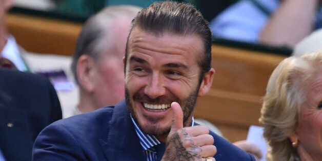 Former England footballer David Beckham gestures as he sits in the Royal Box on Centre Court on the fifth day of the 2017 Wimbledon Championships at The All England Lawn Tennis Club in Wimbledon, southwest London, on July 7, 2017. / AFP PHOTO / Glyn KIRK / RESTRICTED TO EDITORIAL USE (Photo credit should read GLYN KIRK/AFP/Getty Images)