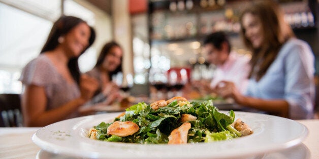 People having dinner at a restaurant - focus on foregroup