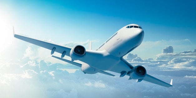 Mid-sized passanger airplane flying above clouds.