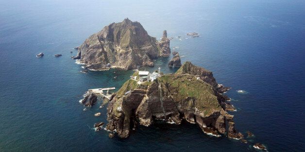 A set of remote islands called Dokdo in Korean and Takeshima in Japanese is seen in this picture taken from a helicopter carrying South Korean President Lee Myung-bak (not pictured), east of Seoul August 10, 2012. Lee visited the islands on Friday, angering neighbour Japan which also lays claims to territory. South Korea controls the islands with a coast guard presence and plans to beef up maritime research. REUTERS/The Blue House/Handout (POLITICS) FOR EDITORIAL USE ONLY. NOT FOR SALE FOR MARKETING OR ADVERTISING CAMPAIGNS. THIS IMAGE HAS BEEN SUPPLIED BY A THIRD PARTY. IT IS DISTRIBUTED, EXACTLY AS RECEIVED BY REUTERS, AS A SERVICE TO CLIENTS