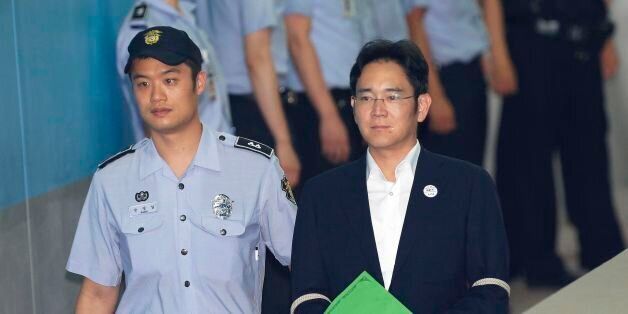 Lee Jae-yong (front R), vice chairman of Samsung Electronics Co., arrives for his trial at the Seoul Central District Court in Seoul on August 7, 2017.South Korean prosecutors on August 7 demanded the heir to the Samsung empire be jailed for 12 years over his role in the corruption scandal that brought down the country's last president. / AFP PHOTO / POOL / Ahn Young-joon (Photo credit should read AHN YOUNG-JOON/AFP/Getty Images)