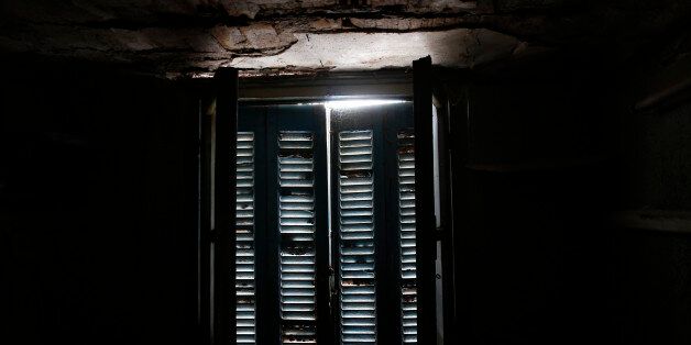 Daylight shines through a closed window at an auxiliary room at the