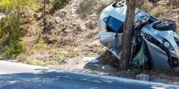 RHODES, GREECE - AUGUST 23: A dammaged car that had a severe accident and smashed into a pine tree on August 23, 2012 in Rhodes, Greece . Rhodes is the largest of the Greek Dodecanes Islands. (Photo by EyesWideOpen/Getty Images)