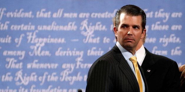 Donald Trump Jr. stands onstage with his father Republican U.S. presidential nominee Donald Trump after Trump's debate against Democratic nominee Hillary Clinton at Hofstra University in Hempstead, New York, U.S. September 26, 2016. REUTERS/Brian Snyder