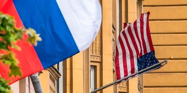 A Russian flag flies next to the US embassy building in Moscow on July 31, 2017.President Vladimir Putin on July 30, 2017 said the United States would have to cut 755 diplomatic staff in Russia and warned of a prolonged gridlock in its ties after the US Congress backed new sanctions against the Kremlin. / AFP PHOTO / Mladen ANTONOV (Photo credit should read MLADEN ANTONOV/AFP/Getty Images)