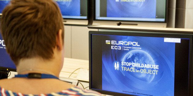 A Europol police agent looks at the onscreen logo of a new website launched by Europol at the Europol headquarters in The Hague on May 31, 2017. A particular shampoo brand, a magazine cover, a shopping bag or even a pattern on wallpaper are some clues Europol posted online on June 1, 2017, hoping it will help investigators identify child sex abuse victims.Europe's police agency launched a new website that shows everyday objects found in the background of child sex abuse images, which they hope will lead police around the world to victims and arrest perpetrators. / AFP PHOTO / Jan HENNOP (Photo credit should read JAN HENNOP/AFP/Getty Images)