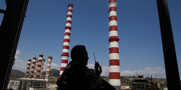 A Public Power Corporation's (PPC) employee speaks on a two-way radio at the natural gas-fired power station at Lavrio town southeast of Athens May 13, 2011. Greece's cash-strapped government, which owns 51 percent of PPC, plans to sell as much as 17 percent in the company next year as part of its 50 billion euro privatisation drive to pay down debt and avoid bankruptcy. PPC's labour union GENOP opposes the move and threatens rolling 48-hour strikes to prevent it. REUTERS/Yiorgos Karahalis (GREECE - Tags: BUSINESS ENERGY POLITICS)