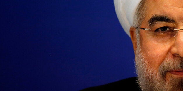 Iran's President Hassan Rouhani attends a news conference at a hotel after the fourth Conference on Interaction and Confidence Building Measures in Asia (CICA) summit, in Shanghai May 22, 2014. Rouhani said on Thursday he is not pessimistic about reaching an agreement over nuclear talks with the United States, Russia, China, France, Britain and Germany. REUTERS/Carlos Barria (CHINA - Tags: POLITICS ENERGY)