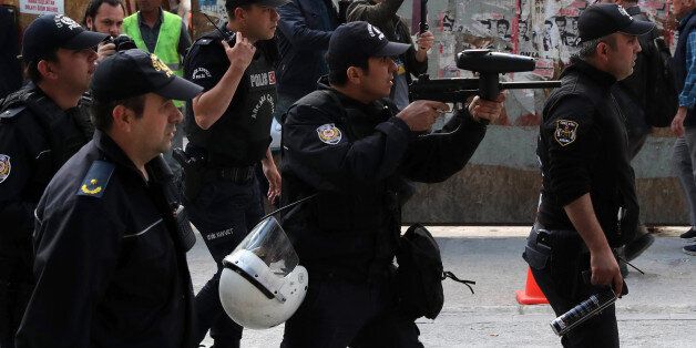 Turkish riot police use tear gas to disperse protesters during a demonstration against the arrest by Turkish authorities of an academic and a teacher who have been on a hunger strike, in Ankara, on May 23, 2017.Turkish authorities detained an academic and a teacher in Ankara who have been on a hunger strike for over two months in protest against their dismissal in the purge that followed last year's failed coup, media reported on May 22. Nuriye Gulmen and Semih Ozakca were sacked under the state of emergency imposed after the July 15 attempted coup seeking to overthrow President Recep Tayyip Erdogan that has seen tens of thousands lose their jobs. / AFP PHOTO / ADEM ALTAN (Photo credit should read ADEM ALTAN/AFP/Getty Images)