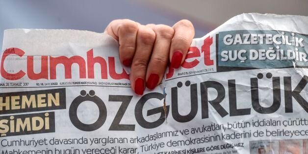 A woman holds a copy of today's Cumhuriyet daily newspaper with a word on the frontpage which can be translated as 'Freedom' on July 28, 2017 during a demonstration in front of Istanbul's courthouse.A Turkish court was due on July 28 to decide whether to release journalists from the opposition newspaper Cumhuriyet jailed on charges of supporting 'terrorism', in a trial seen as a test for press freedom under President Recep Tayyip Erdogan. / AFP PHOTO / OZAN KOSE (Photo credit should read OZAN KOSE/AFP/Getty Images)