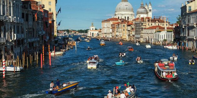 VENICE, ITALY - JULY 15: Boats sail the Grand Canal to reach the St. Mark basin on the day of the Redentore Celebrations on July 15, 2017 in Venice, Italy. Redentore, which is in remembrance of the end of the 1577 plague, is one of Venice's most loved celebrations. Highlights of the celebration include the pontoon bridge extending across the Giudecca Canal, gatherings on boats in the St. Mark's Basin and a spectacular fireworks display. (Photo by Awakening/Getty Images)