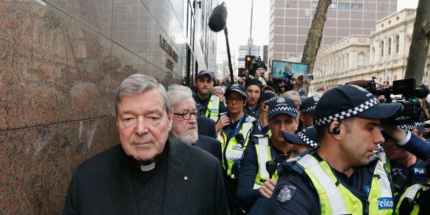 MELBOURNE, AUSTRALIA - JULY 26: Cardinal George Pell walks with a heavy Police guard from the Melbourne Magistrates' Court on July 26, 2017 in Melbourne, Australia. Cardinal Pell was charged on summons by Victoria Police at Melbourne Magistrates' Court on July 26, 2017 in Melbourne, Australia. Cardinal George Pell was charged on summons by Victoria Police on 29 June over multiple allegations of sexual assault. Cardinal George Pell is Australia's highest ranking Catholic and the third most senior Catholic at the Vatican, where he was responsible for the church's finances. Cardinal George Pell has leave from his Vatican position while he defends the charges. (Photo by Michael Dodge/Getty Images)