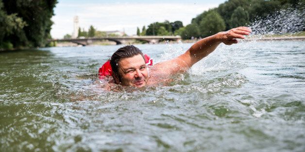 MUNICH, GERMANY - JUNE 28: Benjamin David swims in the Isar river on June 28, 2017 in Munich, Germany. In order to avoid overcrowded streets and bicycle paths, David regularly swims about 2 kilometers from the river's shore in front of his house to the Kulturstrand (Culture Beach) at the Deutsches Museum (German Museum). PHOTOGRAPH BY DPA / Barcroft ImagesLondon-T:+44 207 033 1031 E:hello@barcroftmedia.com -New York-T:+1 212 796 2458 E:hello@barcroftusa.com -New Delhi-T:+91 11 4053 2429 E:hello@barcroftindia.com www.barcroftmedia.com (Photo credit should read DPA / Barcroft Images / Barcroft Media via Getty Images)