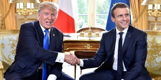 French President Emmanuel Macron (R) shakes hands with US President Donald Trump (L) during their meeting at the Elysee Palace in Paris on July 13, 2017, during Trump's 24-hour trip that coincides with France's national day and the 100th anniversary of US involvement in World War I.Donald Trump arrived in Paris for a presidential visit filled with Bastille Day pomp and which the White House hopes will offer respite from rolling scandal backing home. / AFP PHOTO / POOL / ALAIN JOCARD (Phot
