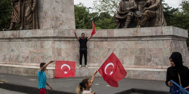 ISTANBUL, TURKEY - JULY 14: People wave Turkish flags while attending a rally to honour the victims of the July 15, 2016 coup attempt a day ahead of the first anniversary of the failed coup attempt on July 14, 2017 in Istanbul, Turkey. July 15, 2017 will mark the first anniversary of the failed coup attempt which saw 249 people die when military personnel attempted to over throw the government and President Recep Tayyip Erdogan. Extensive commemorations have been planned for the July 15 anniversary and the day has been declared an annual holiday. (Photo by Chris McGrath/Getty Images)