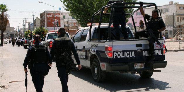 Ciudad Juarez, Mexico - August 8, 2011: Police officers escort the hearse carrying the body of an officer killed in the line of duty, allegedly by members of a drug gang, at his funeral. Ciudad Juarez was the deadliest city in Mexico at this time due to drug gang violence.
