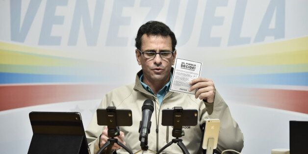 Henrique Capriles, opposition leader and governor of the State of Miranda, holds a voting card as he speaks during a press conference in Caracas, Venezuela, on Saturday, July 15, 2017. On Sunday, the opposition will hold an unofficialÂ plebisciteÂ on President Nicolas Maduro's efforts to rewrite the constitution, an act of civil disobedience where they hope to draw out millions. Photographer: Carlos Becerra/Bloomberg via Getty Images