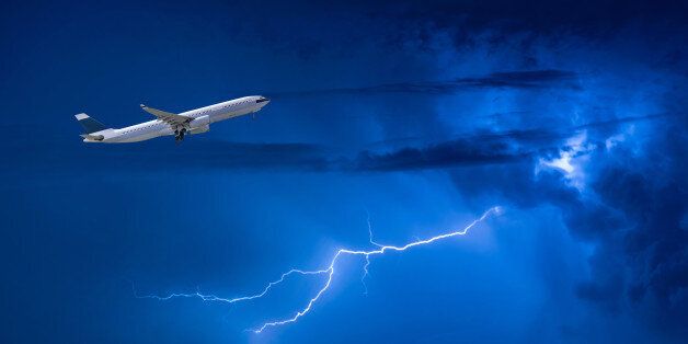 Commercial airplane take off flying over storm clouds and lightning. Elegant Design with copy space for travel concept.