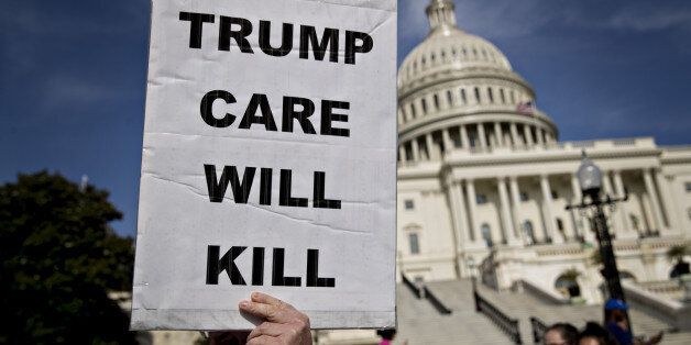 A demonstrator opposed to the Senate Republican health-care holds a sign that reads 'Trump Care Will Kill' while marching near the U.S. Capitol in Washington, D.C., U.S., on Wednesday, June 28, 2017. Several Senate Republicans began to question today whether their health-care bill should repeal a tax on high-income Americans imposed by Obamacare when the legislation would scale back subsidies for the poor. Photographer: Andrew Harrer/Bloomberg via Getty Images