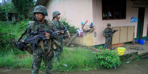 This photo taken on July 12, 2017 shows Philippine troops standing guard prior to a patrol in Marawi on the southern island of Mindanao. A Philippine military jet accidentally killed two soldiers and injured 11 others as troops fought to retake a southern city from pro-Islamic State group militants, the military said on July 13, 2017. / AFP PHOTO / RICHEL UMEL (Photo credit should read RICHEL UMEL/AFP/Getty Images)
