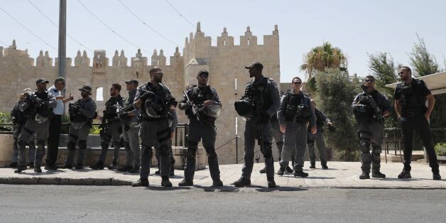 Israeli security forces stand guard in Jerusalem's Old City on July 14, 2017 following a shooting attack.Three assailants opened fire on Israeli police in Jerusalem's Old City before fleeing to a nearby highly sensitive holy site and being killed by security forces, police said. / AFP PHOTO / Thomas COEX (Photo credit should read THOMAS COEX/AFP/Getty Images)