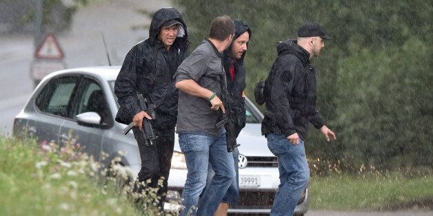 Police officers walk under heavy rain during the hunting in Uhwiesen northern Switzerland, of a man armed with a chainsaw who injured at least five people in Schaffhausen on July 24, 2017.A man armed with a chainsaw injured at least five people in Switzerland on Monday and is on the run after a rampage that police said was not 'a terrorist act'. The assailant entered an office building in the northern town of Schaffhausen shortly after 10:30 am (0830 GMT), police said in a statement cited by multiple local media outlets. / AFP PHOTO / MICHAEL BUHOLZER (Photo credit should read MICHAEL BUHOLZER/AFP/Getty Images)