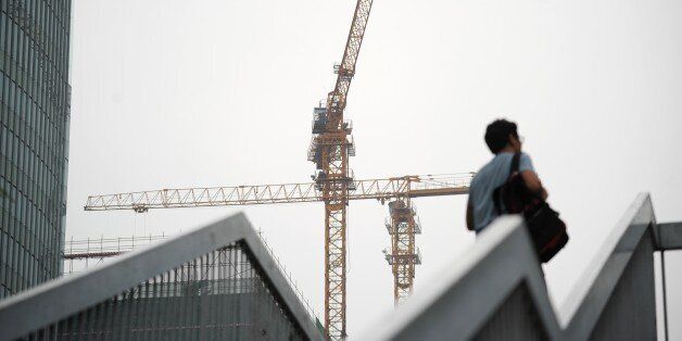 Tower cranes are seen at a construction site in Beijing on July 17, 2017.China posted better-than-expected growth in the second quarter, official data showed on July 17, but authorities warned that the world's second largest economy faces external and internal risks. / AFP PHOTO / WANG ZHAO (Photo credit should read WANG ZHAO/AFP/Getty Images)