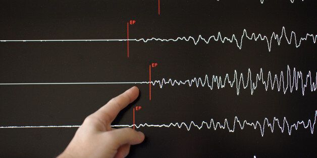 A technician of the French National Seism Survey Institute (RENASS) presents a graph on March 11, 2011 in Strasbourg, Eastern France, registered today during a major earthquake in Japan. A 8.9 magnitude quake hit northeast Japan today, causing many injuries, deaths, fires and a tsunami along parts of the country's coastline. AFP PHOTO / FREDERICK FLORIN (Photo credit should read FREDERICK FLORIN/AFP/Getty Images)
