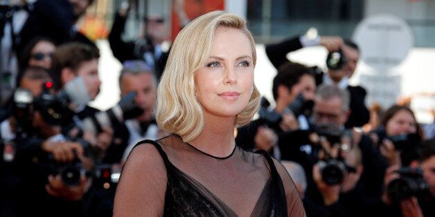 70th Cannes Film Festival - Event for the 70th Anniversary of the festival - Red Carpet Arrivals - Cannes, France. 23/05/2017. Actress Charlize Theron poses. REUTERS/Jean-Paul Pelissier