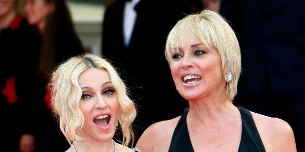 Singer Madonna (L) and actress Sharon Stone arrive on the red carpet before the screening of