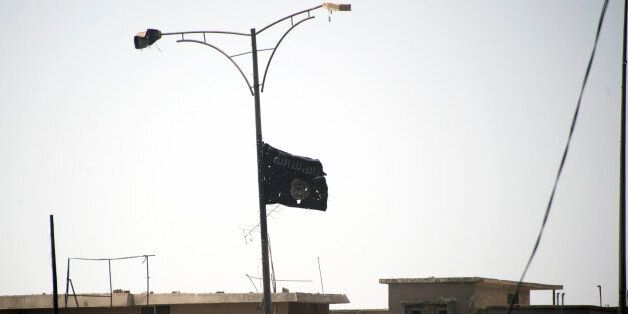 A picture taken on July 1, 2017, shows the black flag of the Islamic State (IS) group moving in the wind near the medical complex in the Shifa neighbourhood, on the west bank of Mosul, on July 1, 2017, where they are battling some of the last members of the Islamic State (IS) jihadist group in the city. / AFP PHOTO / Fadel SENNA (Photo credit should read FADEL SENNA/AFP/Getty Images)