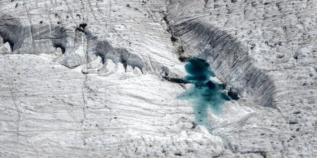 A picture shows water on a melting glacier, next to the 3,135 m Gornergrat (Gorner Ridge) above Zermatt, Swiss Alps, on June 30, 2015. AFP PHOTO / FABRICE COFFRINI (Photo credit should read FABRICE COFFRINI/AFP/Getty Images)