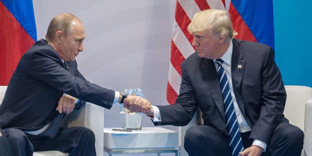 HAMBURG, GERMANY - JULY 07: Russian President Vladimir Putin (left) and President of the United States of America Donald Trump (right) shake hands during the meeting at G20 Summit on July 7, 2017 in Hamburg, Germany. (Photo by Dmitry Azarov/Kommersant via Getty Images)