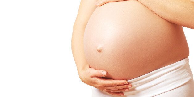 belly tummy of a pregnant woman on a white background
