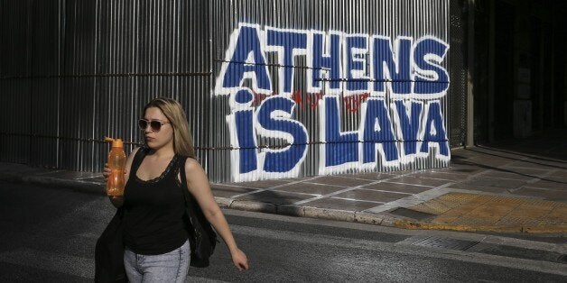 ATHENS, GREECE - JULY 1: People walk at the street during the hot summer day in Athens, Greece on July 1, 2017. (Photo by Ayhan Mehmet/Anadolu Agency/Getty Images)