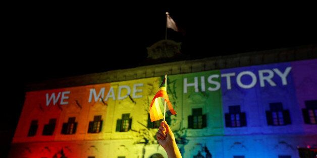 The Auberge de Castille, the office of Prime Minister Joseph Muscat, is lit in rainbow colours as people celebrate after the Maltese parliament voted to legalise same-sex marriage on the Roman Catholic Mediterranean island, in Valletta, Malta, July 12, 2017. REUTERS/Darrin Zammit Lupi