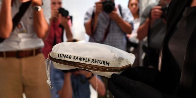 Sothebys Cassandra Hatton displays the Apollo 11 Contingency Lunar Sample Return Bag, used by Neil Armstrong on Apollo 11 to bring back the very first pieces of the moon ever collected, during a media preview for Space Exploration auction in New York on July 13, 2017. / AFP PHOTO / Jewel SAMAD (Photo credit should read JEWEL SAMAD/AFP/Getty Images)