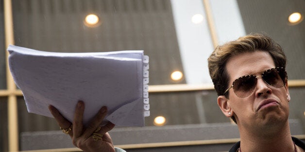 NEW YORK, NY - JULY 7: Milo Yiannopoulos holds up a copy of a legal complaint as he speaks outside the offices of Simon & Schuster publishing company, July 7, 2017 in New York City. Yiannopoulos is promoting a new book and filing a $10 million legal complaint against Simon & Schuster following the publisher's decision to cancel his book deal. (Photo by Drew Angerer/Getty Images)