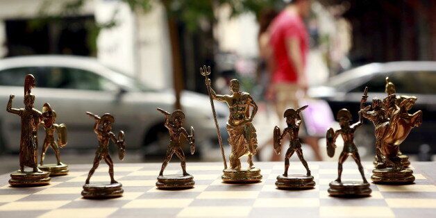 Chess pieces depicting Greek gods and Spartan soldiers on display in a shop in Athens, Greece July 11, 2015. Skeptical European finance ministers gathered on Saturday to decide whether to negotiate a third bailout for Greece after Prime Minister Alexis Tsipras won lawmakers' backing for painful austerity measures his leftist party was elected to prevent. REUTERS/Cathal McNaughton