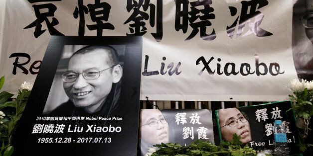 Pro-democracy activists mourn the death of Nobel Laureate Liu Xiaobo, outside China's Liaison Office in Hong Kong, China July 13, 2017. REUTERS/Bobby Yip