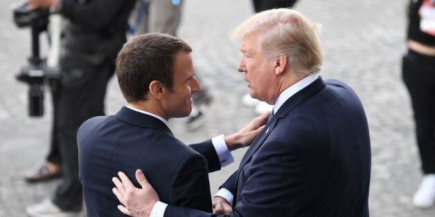 US President Donald Trump (R) and French President Emmanuel Macron shake hands at the end of the annual Bastille Day military parade on the Champs-Elysees avenue in Paris on July 14, 2017. The parade on Paris's Champs-Elysees will commemorate the centenary of the US entering WWI and will feature horses, helicopters, planes and troops. / AFP PHOTO / ALAIN JOCARD (Photo credit should read ALAIN JOCARD/AFP/Getty Images)