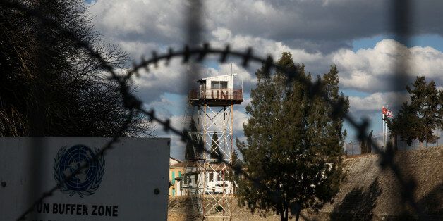 An abandoned UN outpost is seen behind the barbed wire inside the UN-controlled buffer zone in Nicosia, Cyprus February 16, 2017. REUTERS/Yiannis Kourtoglou