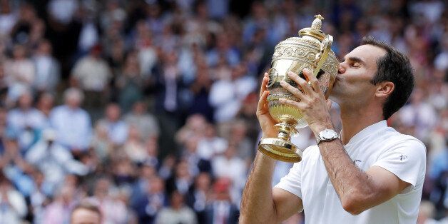 Tennis - Wimbledon - London, Britain - July 16, 2017 Switzerlandâs Roger Federer poses with the trophy as he celebrates winning the final against Croatiaâs Marin Cilic REUTERS/Andrew Couldridge