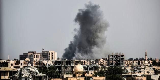 Smoke billows following an airstrike on the western frontline of Raqa on July 17, 2017, during an offensive by the US-backed Syrian Democratic Forces, a majority Kurdish and Arab alliance, to retake the city from Islamic State (IS) group fighters.Heavy bombardment and fierce fighting shook the Islamic State group's Syrian stronghold Raqa, as SDF said they captured a new neighbourhood from entrenched jihadists. Bursts of gunfire and artillery as well as the thud of air strikes conducted by the US-led coalition filled the air in western neighbourhoods of Raqa, on what AFP's correspondent said was the heaviest day of bombardment to date. / AFP PHOTO / BULENT KILIC (Photo credit should read BULENT KILIC/AFP/Getty Images)